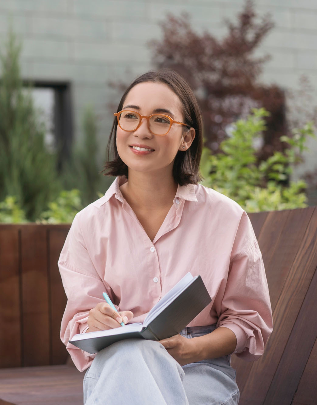 Woman writing on her notebook smiling